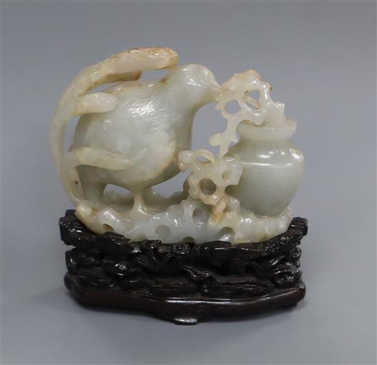 A Chinese pale celadon and russet jade quail carving, wood stand 10cm high including stand